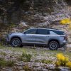 Side profile view of 2024 Chevrolet Traverse Z71 driving up mountain road