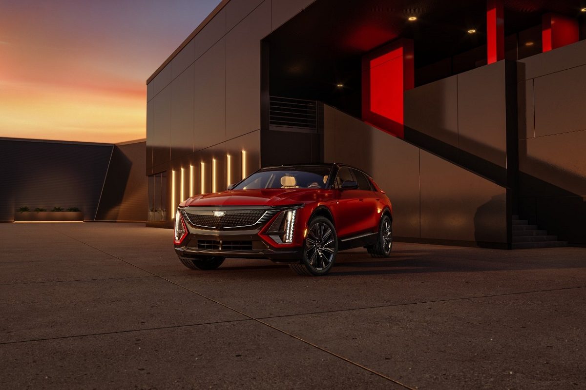 Front driver’s side 3/4 view of the 2024 Cadillac LYRIQ Sport trim with front grille illuminated.