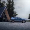 Side profile view of 2024 GMC Acadia Denali parked near A-frame building