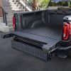 Rear side view of 2024 GMC Sierra Denali Ultimate with CarbonPro bed and open MultiPro Tailgate