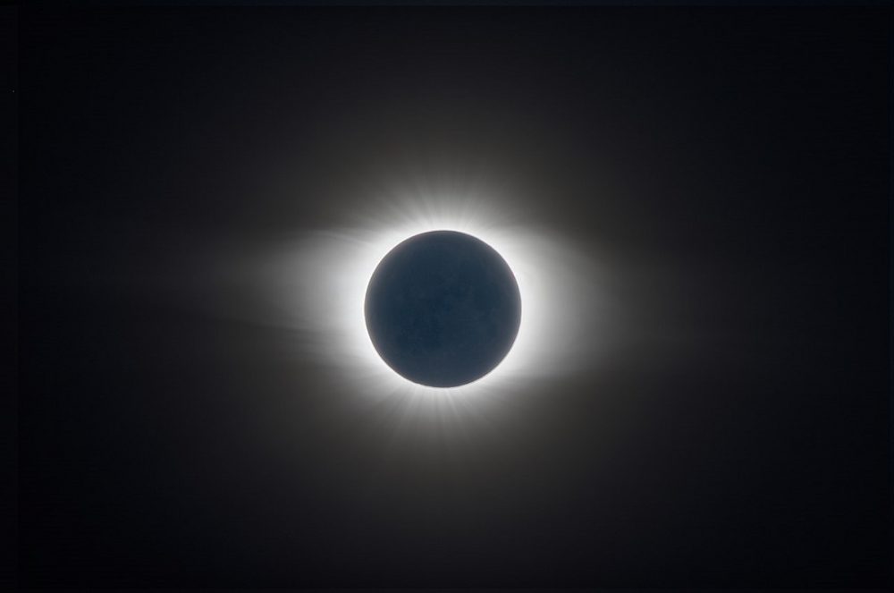 A photo of the moon fully covering the sun during a total solar eclipse