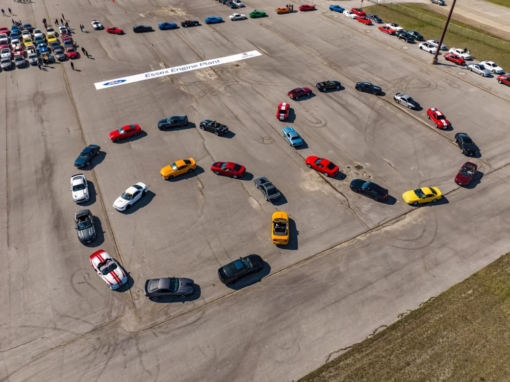 Ford Mustangs gathered in the Ford HQ parking lot spell out the number 60 on the pony car's 60h anniversary