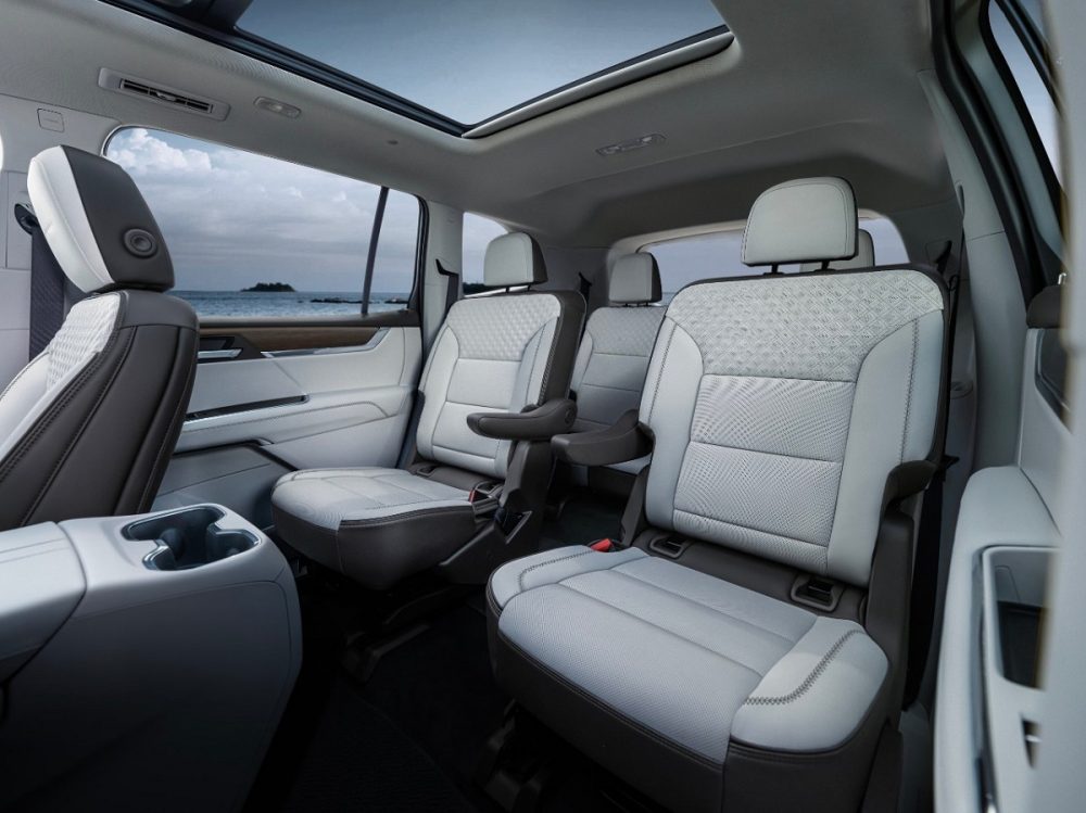 An interior view of the 2024 GMC Acadia Denali showing its perforated leather second-row captain's chairs