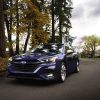 A front side view of the 2025 Subaru Legacy parked near a cluster of trees