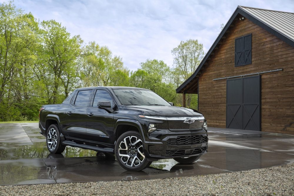 Front 3/4 shot of the 2024 Chevrolet Silverado EV RST parked in front of a barn