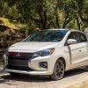 A white 2024 Mitsubishi Mirage is parked in front of a natural backdrop