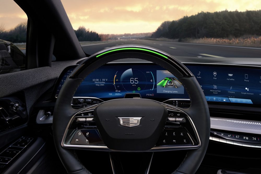 View of the 2025 Cadillac OPTIQ steering wheel with standard Super Cruise and steering wheel light bar activated.