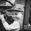 young child boy in driver's seat of car learning to drive