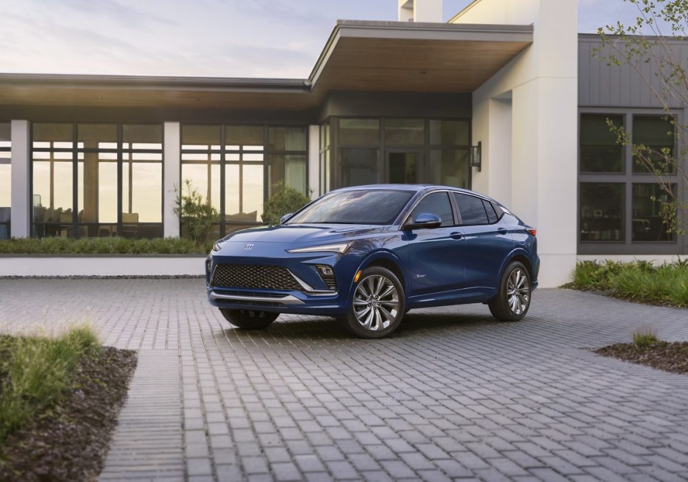 Front 3/4 view of blue 2024 Buick Envista Avenir parked in front of building