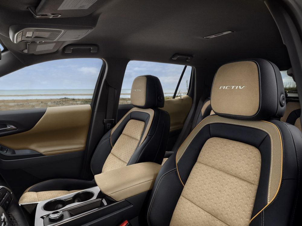 View of Maple Sugar and Black front seats and center console in the 2025 Chevrolet Equinox ACTIV