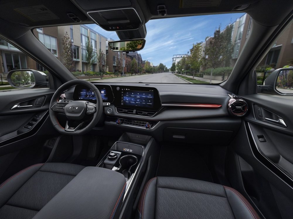 A view of the steering wheel, dashboard, display screens, center console and front seats inside the 2025 Chevrolet Equinox RS