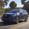 Front 3/4 view of the 2025 Subaru Ascent driving on a highway