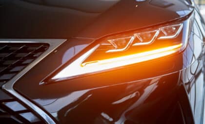 Bright spotlight on a new car in the showroom