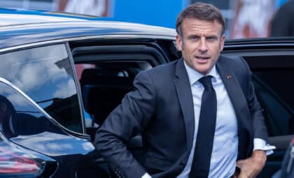 French President Emmanuel Macron gets out of his car