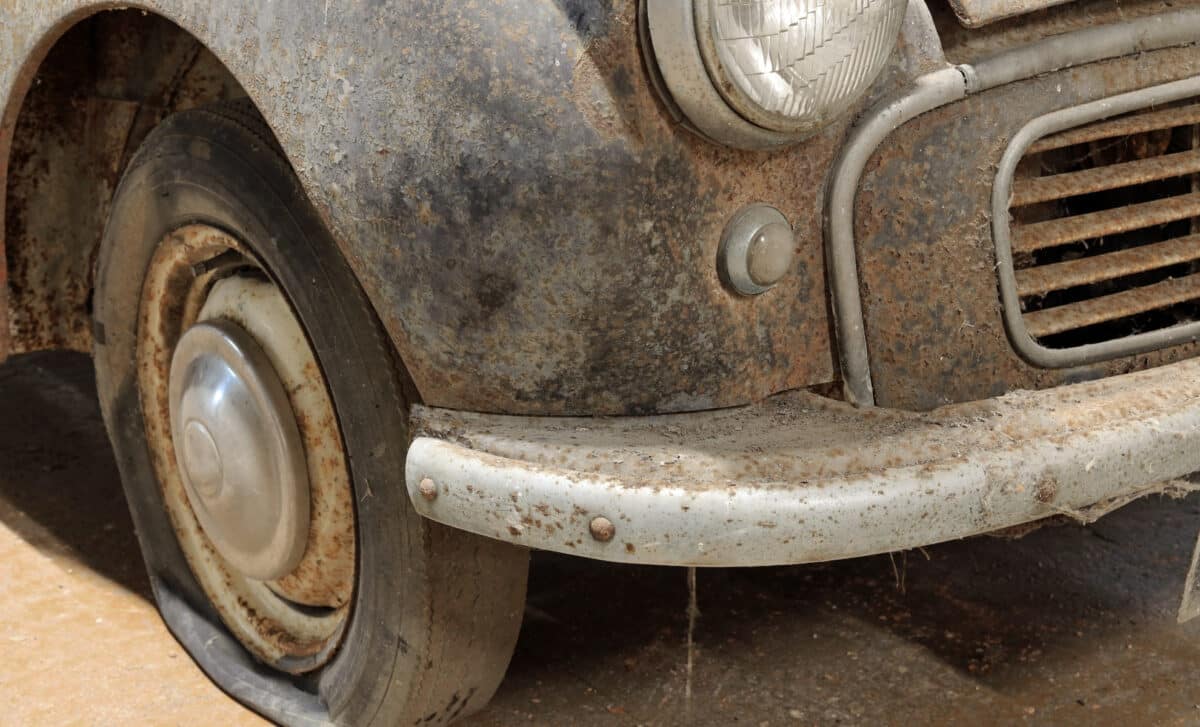 Badly Corroded Rusty Vintage Car Abandoned in a Garage