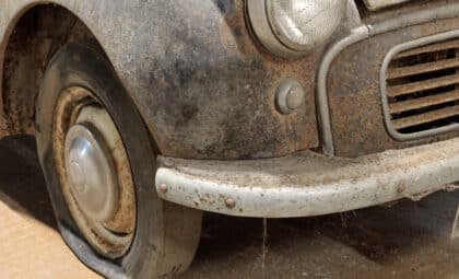 Badly Corroded Rusty Vintage Car Abandoned in a Garage