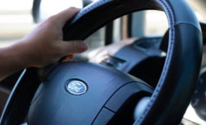 Close-up of a hand on a Ford steering wheel