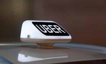 Close-up of an illuminated Uber taxi sign