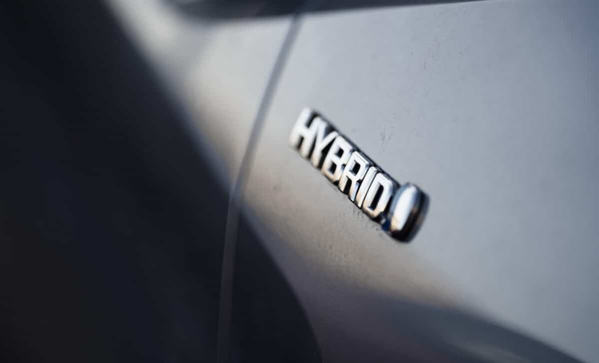 Close-up view of the hybrid logo on a Toyota plugin hybrid car
