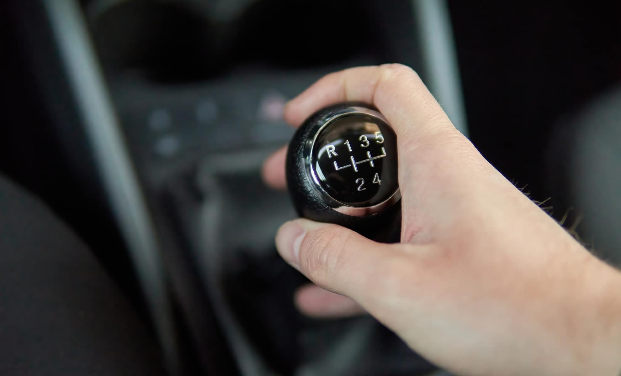man holding manual gearbox transmission gear